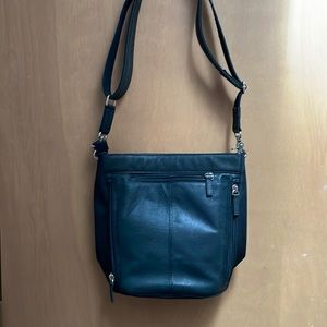 Black adjustable strap shoulder bag with concealed carry pocket.